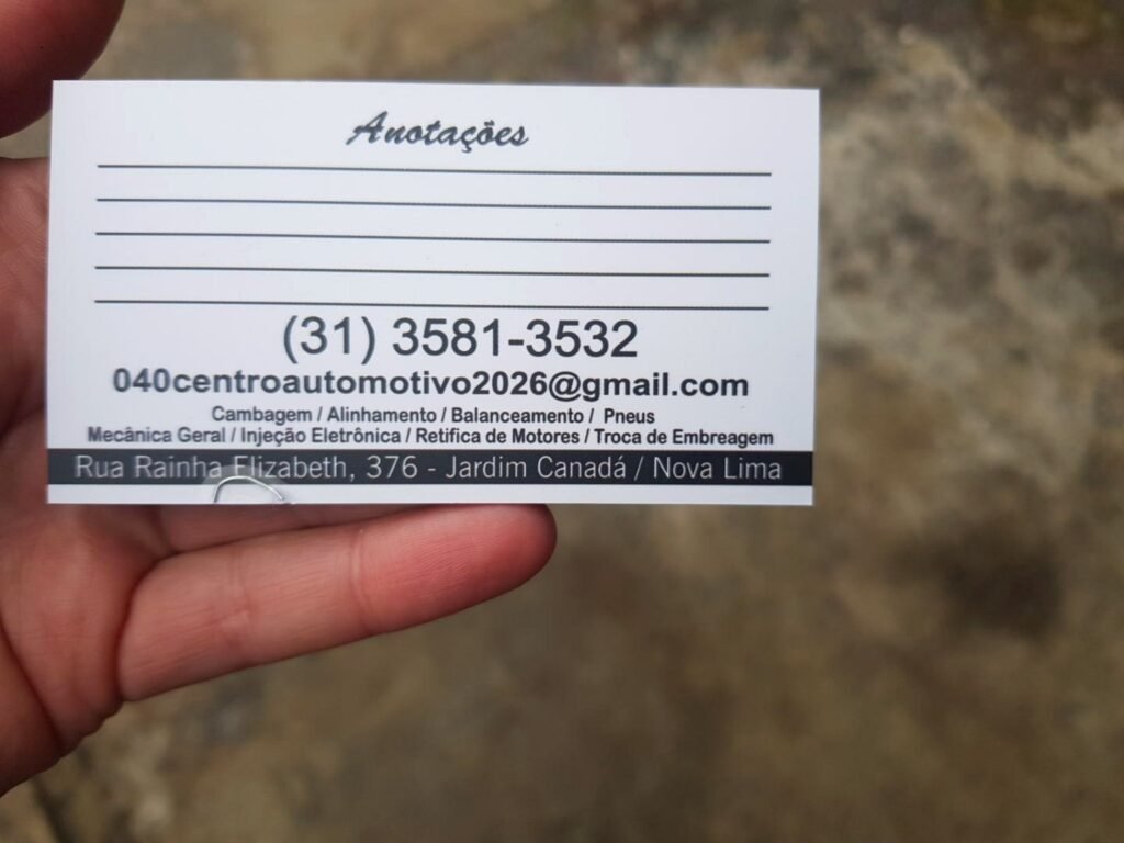 Verso do cartão da 040 Motors com telefone, e-mail, serviços e endereço.